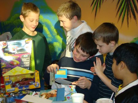 Birthday boy opening gifts